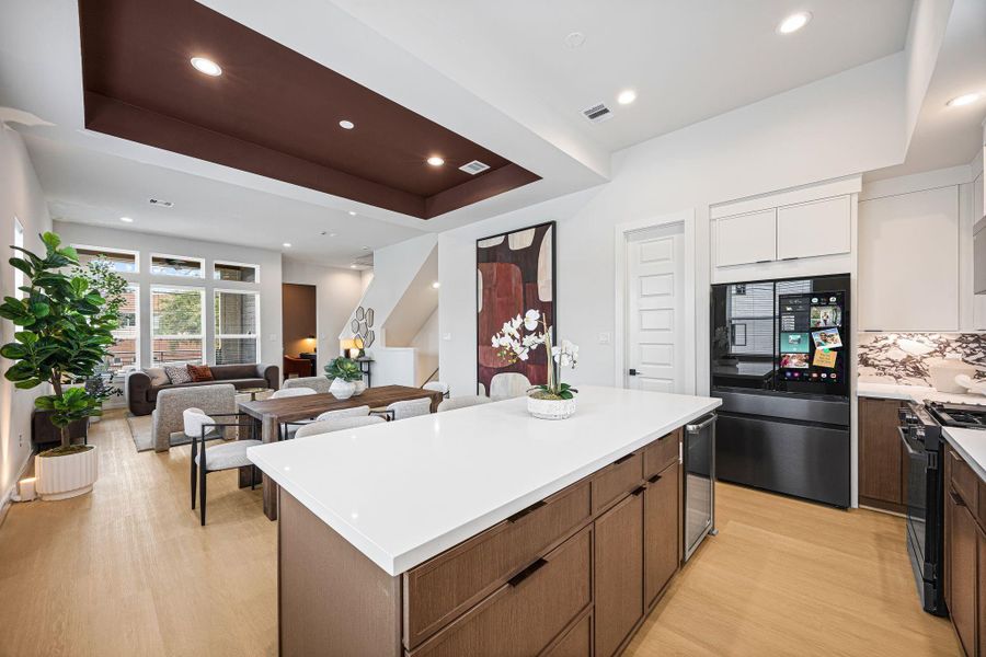 Discover the seamless blend of modern elegance and functionality in this open-concept space, where the sleek kitchen flows effortlessly into the inviting dining and living areas, perfect for entertaining and everyday living. **Model of similar home**