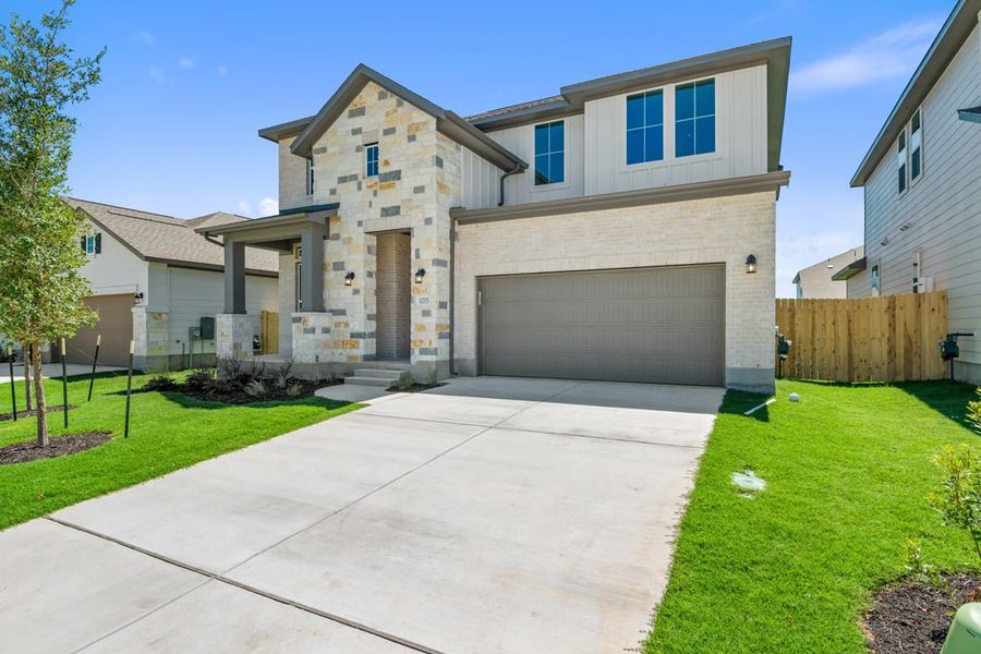 Front exterior of a new home in Lagos Reserve, Manor, TX, highlighting curb appeal (Image 2). Front exterior of a new home in Lagos Reserve, Manor, TX, highlighting curb appeal (Image 2).