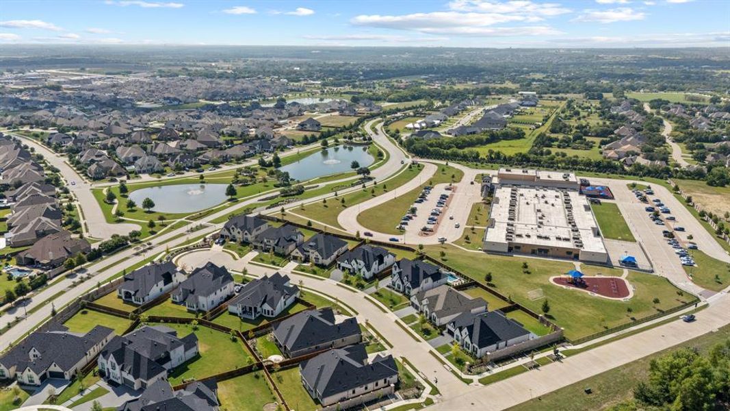Aerial overview of property's location featuring a large body of water and nearby suburban area