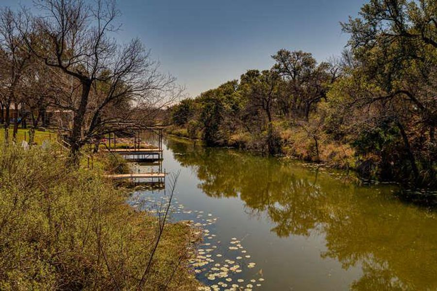 Dock featuring a water view and a wooded view