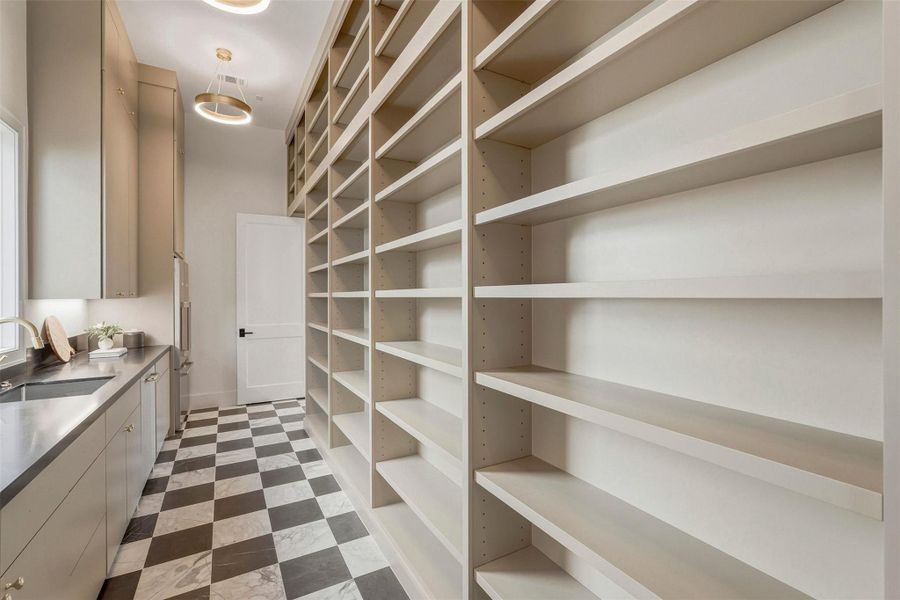 On the opposite side of this chef's kitchen: floor-to-ceiling shelving thoughtfully designed to accommodate your family's every culinary and entertaining need. On the opposite side of this chef's kitchen: floor-to-ceiling shelving thoughtfully designed to accommodate your family's every culinary and entertaining need.