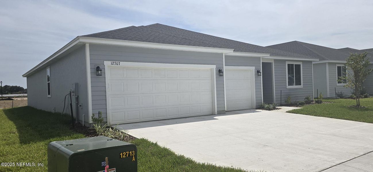 Front exterior of a new home in Azalea Creek, Jacksonville, FL, highlighting curb appeal (Image 20).