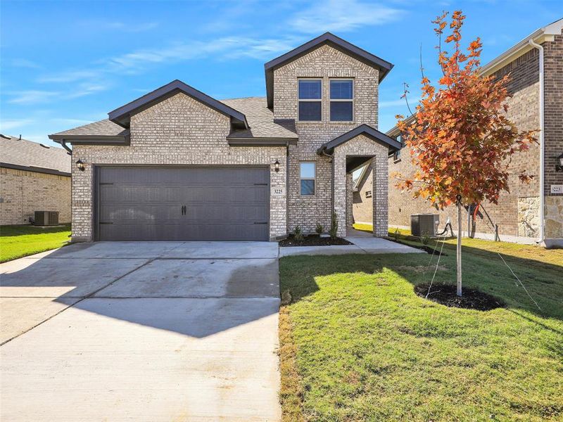 View of front of property featuring brick siding, central AC unit, a front yard, concrete driveway, and an attached garage View of front of property featuring brick siding, central AC unit, a front yard, concrete driveway, and an attached garage