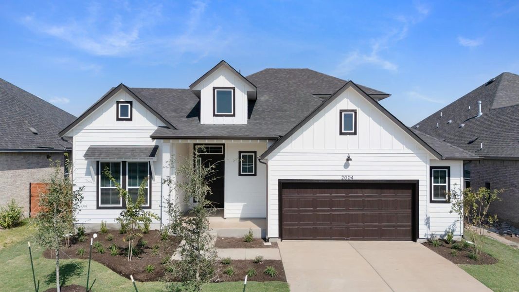 Front exterior of a new home in Highland Village, Georgetown, TX, highlighting curb appeal (Image 1).