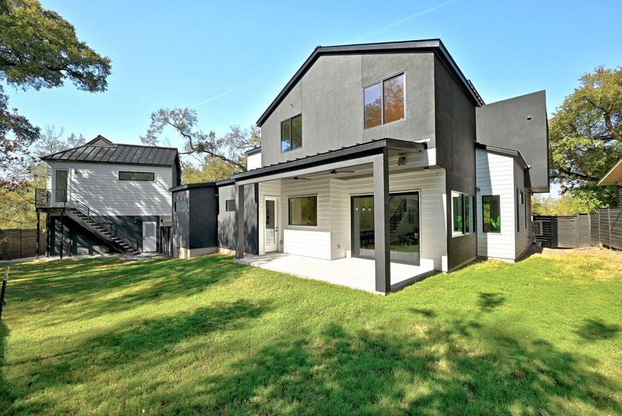 Rear view of backyard featuring a patio and privacy with plenty of space for a pool plus completely fenced backyard