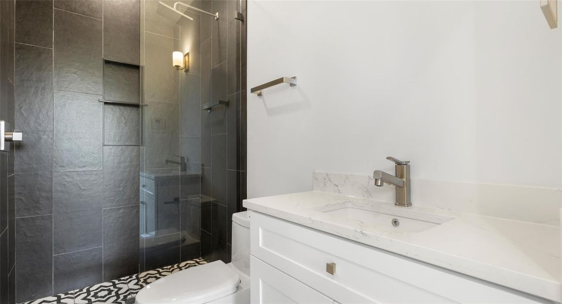 Bathroom featuring vanity and a shower stall