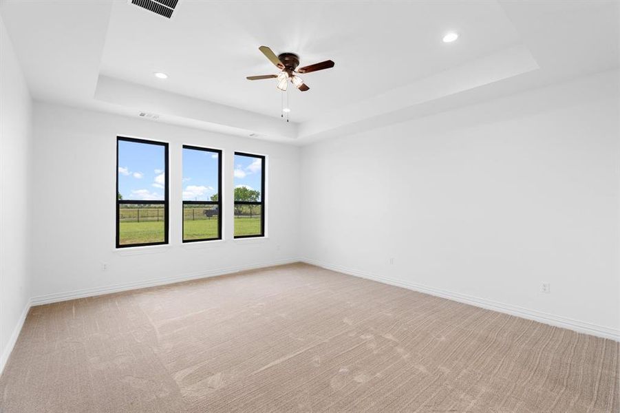 Unfurnished room featuring a tray ceiling, recessed lighting, light carpet, and a ceiling fan Unfurnished room featuring a tray ceiling, recessed lighting, light carpet, and a ceiling fan