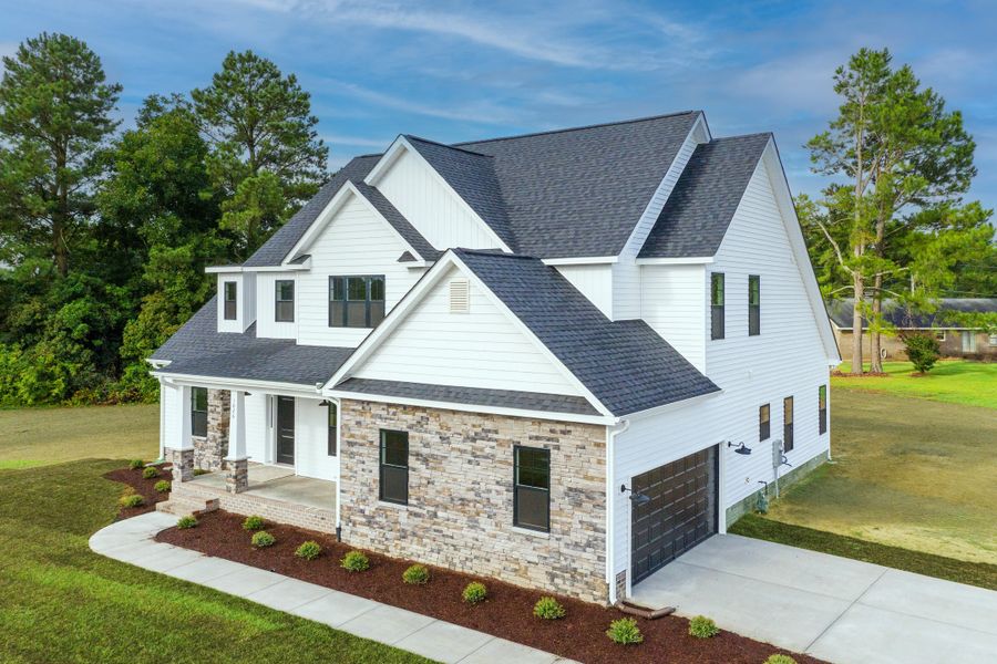 Representative exterior photo of a completed home built from the Carson by Bill Clark Homes in Cheshire Landing, Grimesland, NC (Image 29). Representative exterior photo of a completed home built from the Carson by Bill Clark Homes in Cheshire Landing, Grimesland, NC (Image 29).