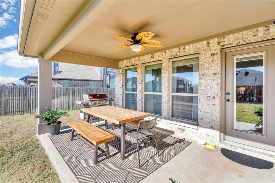 View of patio with area for grilling and ceiling fan