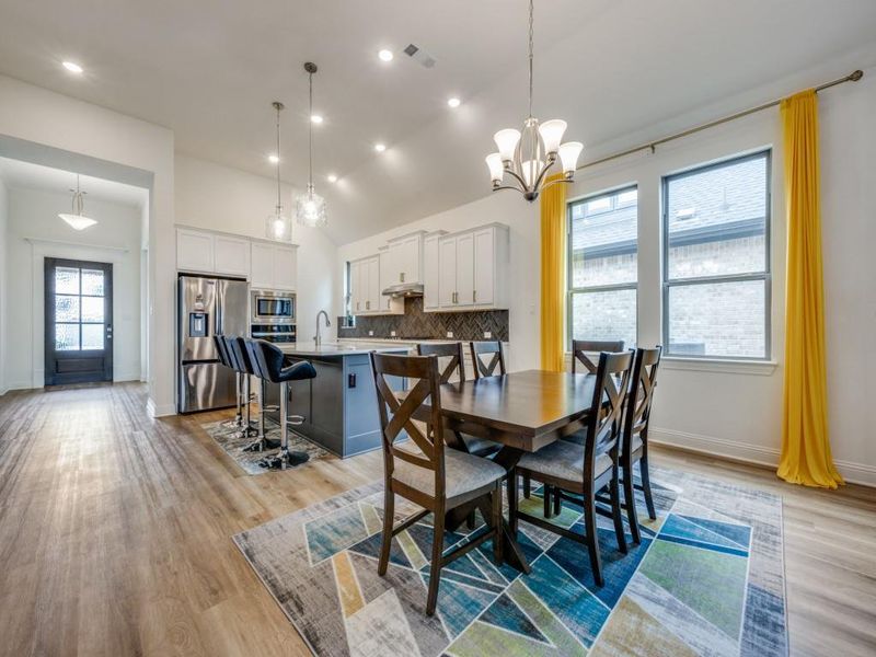 Dining area with recessed lighting, an inviting chandelier, baseboards, light wood finished floors, and visible vents