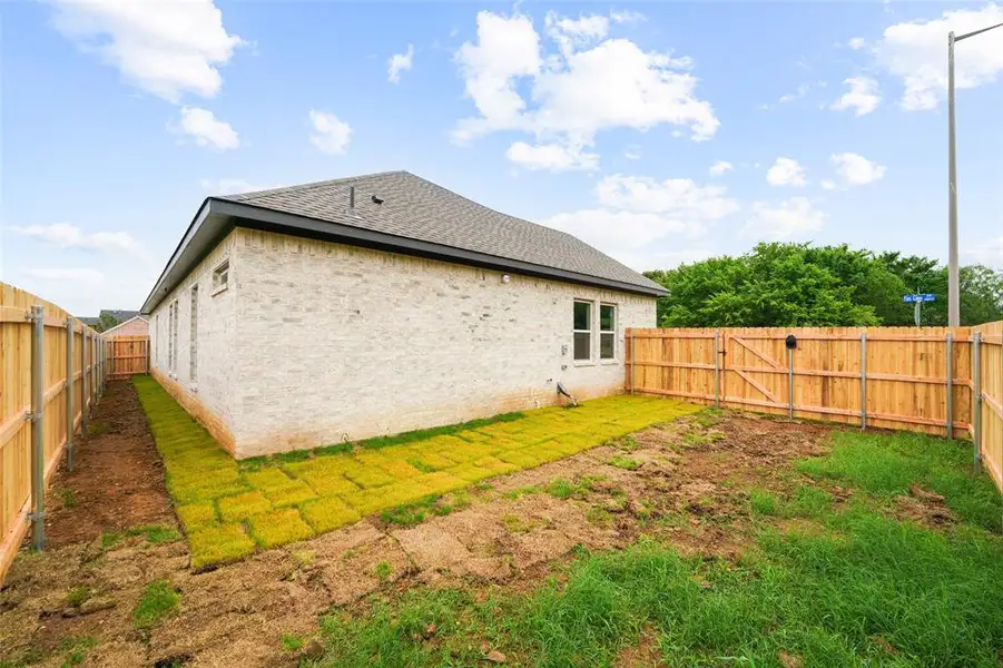 Newly installed wood privacy fence enclosing the backyard