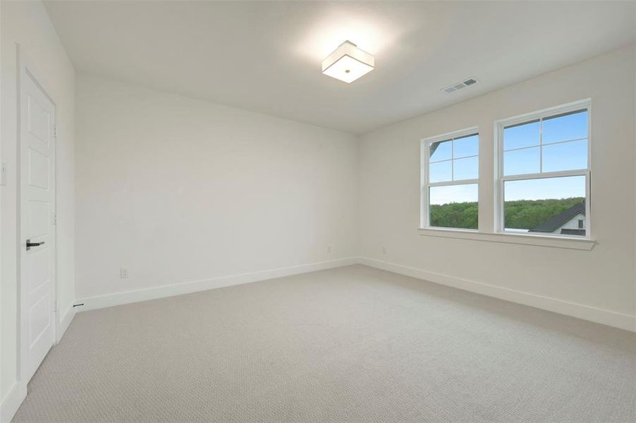Unfurnished bedroom featuring carpet and baseboards