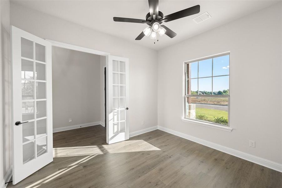 Office featuring ceiling fan and doors for privacy!