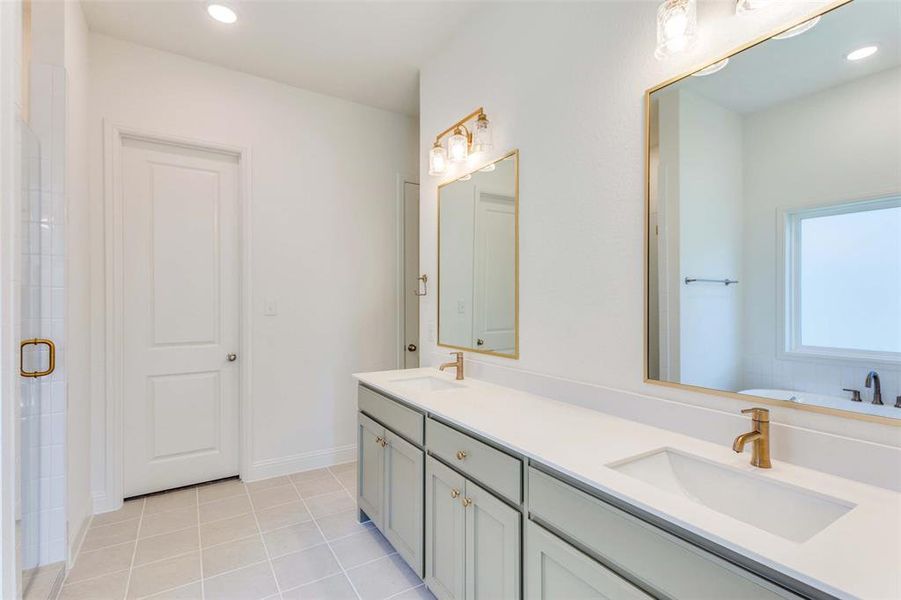 Bathroom with vanity, separate shower and tub, and tile patterned floors