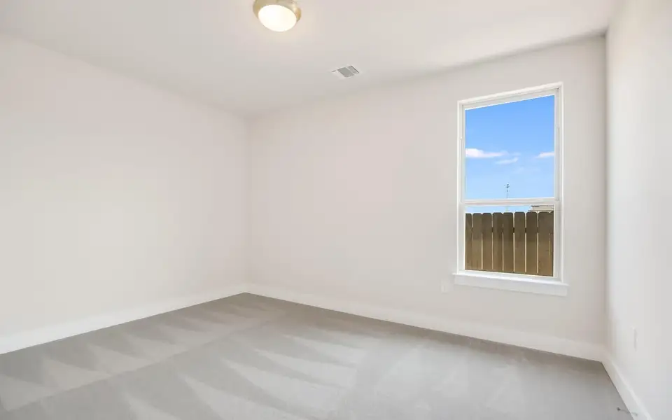 Spare room with light colored carpet