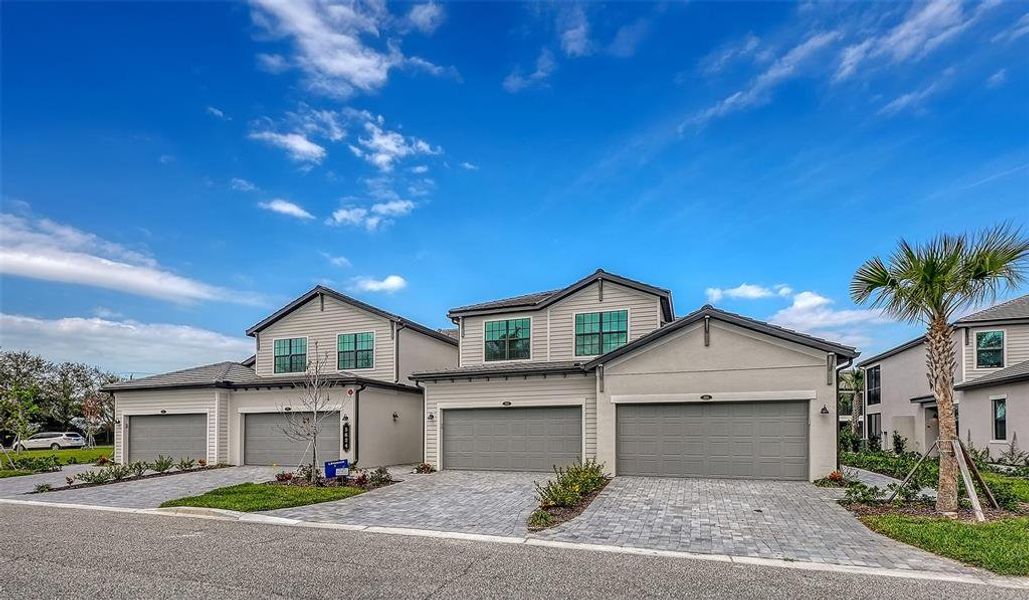 Front exterior of a new home in Legends Cove, Bradenton, FL, highlighting curb appeal (Image 2).