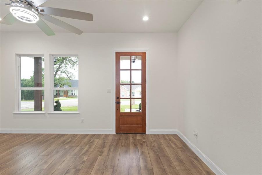 Warm wood-finish flooring complements a multi-paneled wooden door Warm wood-finish flooring complements a multi-paneled wooden door