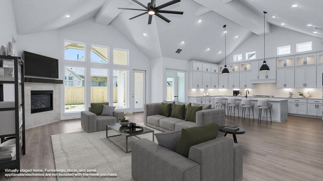 Living room featuring a fireplace, high vaulted ceiling, beamed ceiling, and a ceiling fan Living room featuring a fireplace, high vaulted ceiling, beamed ceiling, and a ceiling fan