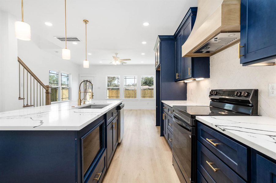 Another angle showcasing the kitchen’s bright, open layout and seamless flow into the living area.