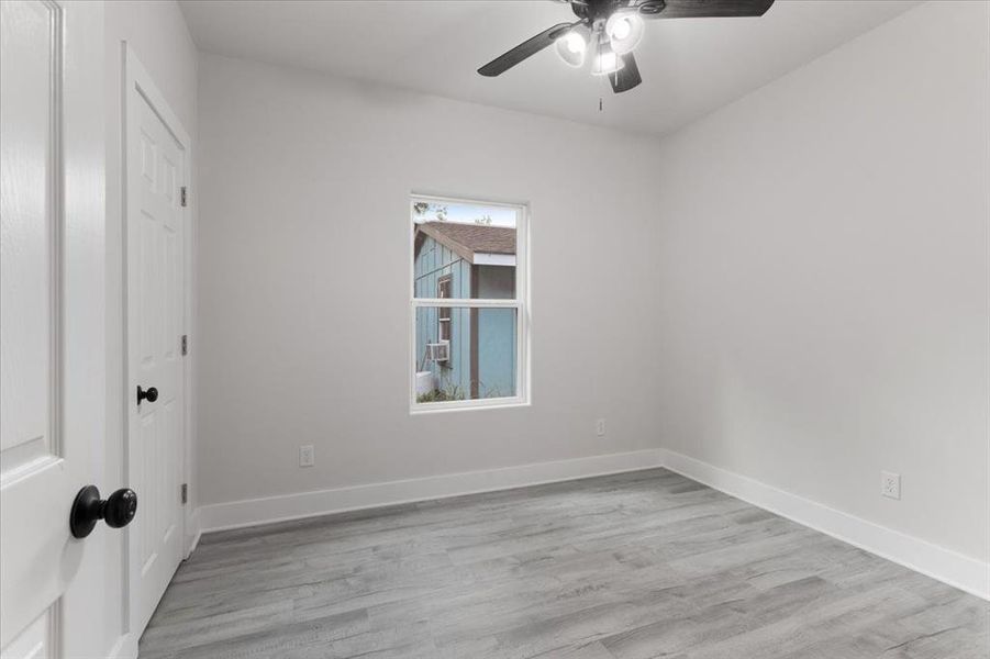 Unfurnished room featuring ceiling fan and light hardwood / wood-style flooring