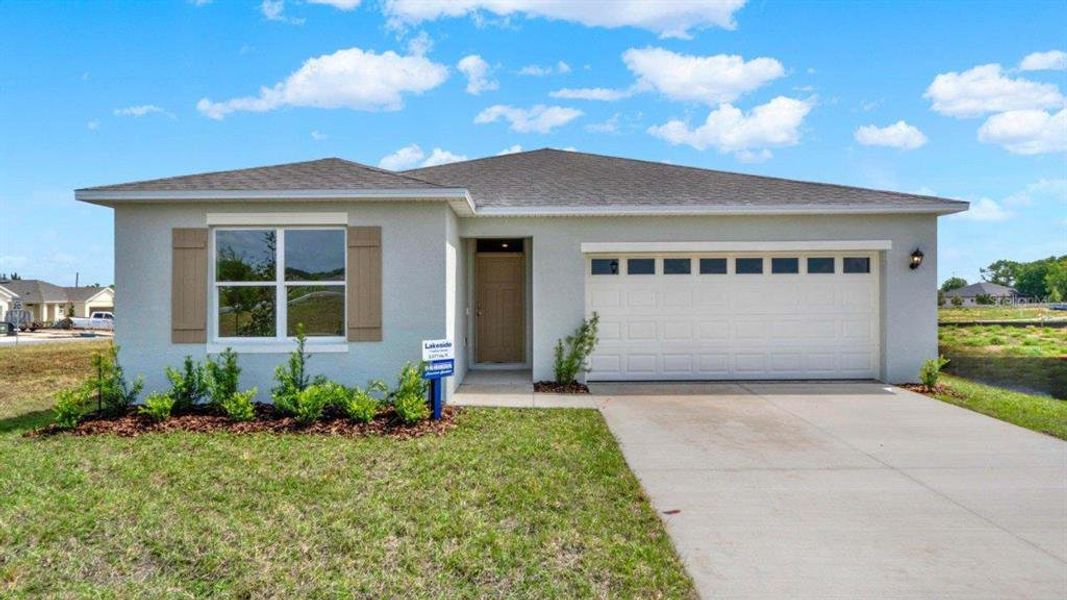 Front exterior of a new home in Annabelle Estates, Lake Wales, FL, highlighting curb appeal (Image 1). Front exterior of a new home in Annabelle Estates, Lake Wales, FL, highlighting curb appeal (Image 1).