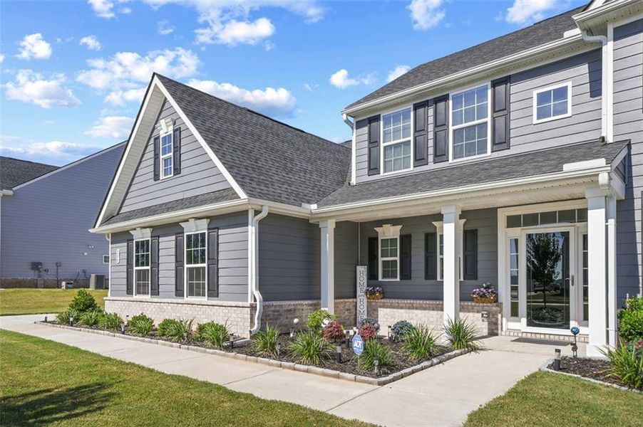 Front exterior of a new home in , Locust Grove, GA, highlighting curb appeal (Image 1).