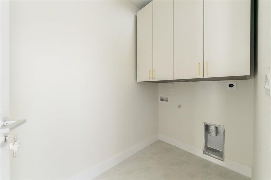 Washroom with cabinet space, hookup for an electric dryer, washer hookup, and gas dryer hookup Washroom with cabinet space, hookup for an electric dryer, washer hookup, and gas dryer hookup