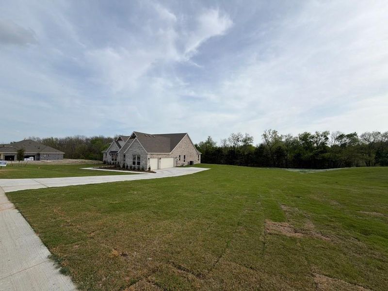 Front exterior of a new home in Grayson Ridge, Van Alstyne, TX, highlighting curb appeal (Image 15).