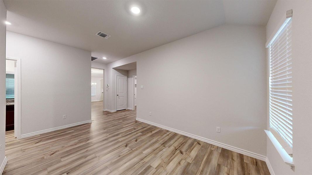 Empty room with light wood-type flooring and baseboards