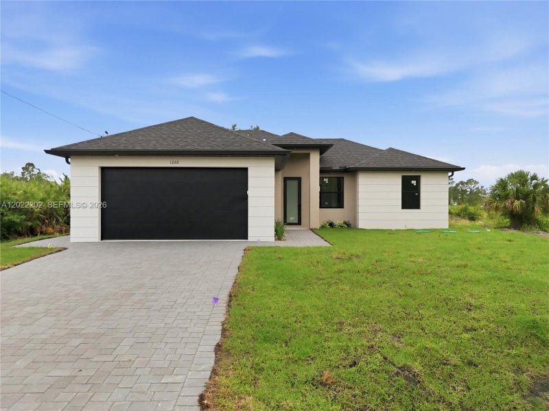 Front exterior of a new home in , Lehigh Acres, FL, highlighting curb appeal (Image 17).