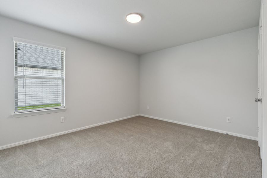 Bedroom in the Hayden home plan by Trophy Signature Homes – REPRESENTATIVE PHOTO