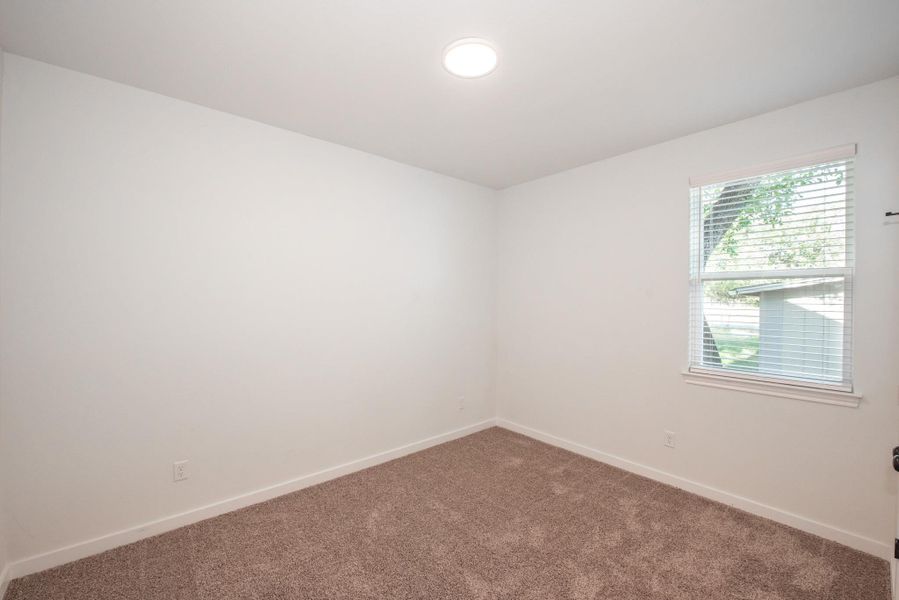 Empty room featuring carpet floors and baseboards