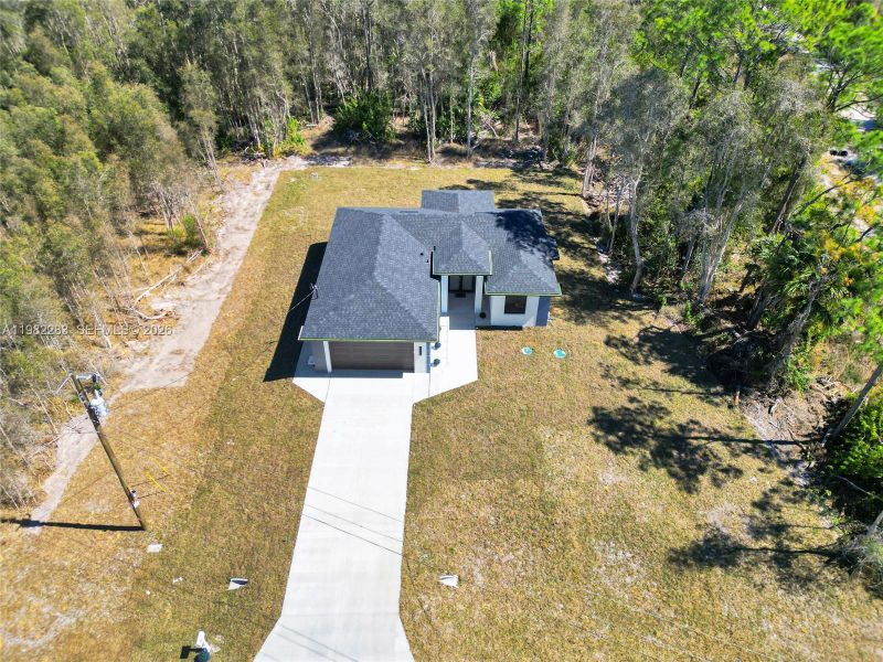 Front exterior of a new home in , Lehigh Acres, FL, highlighting curb appeal (Image 19).