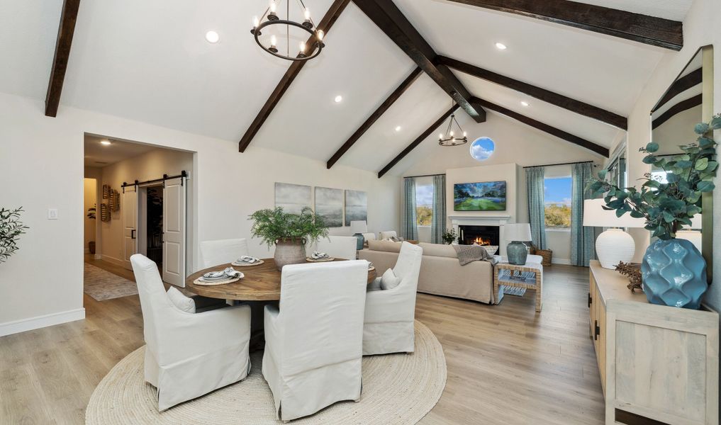 Cozy dining area with stained ceiling beams