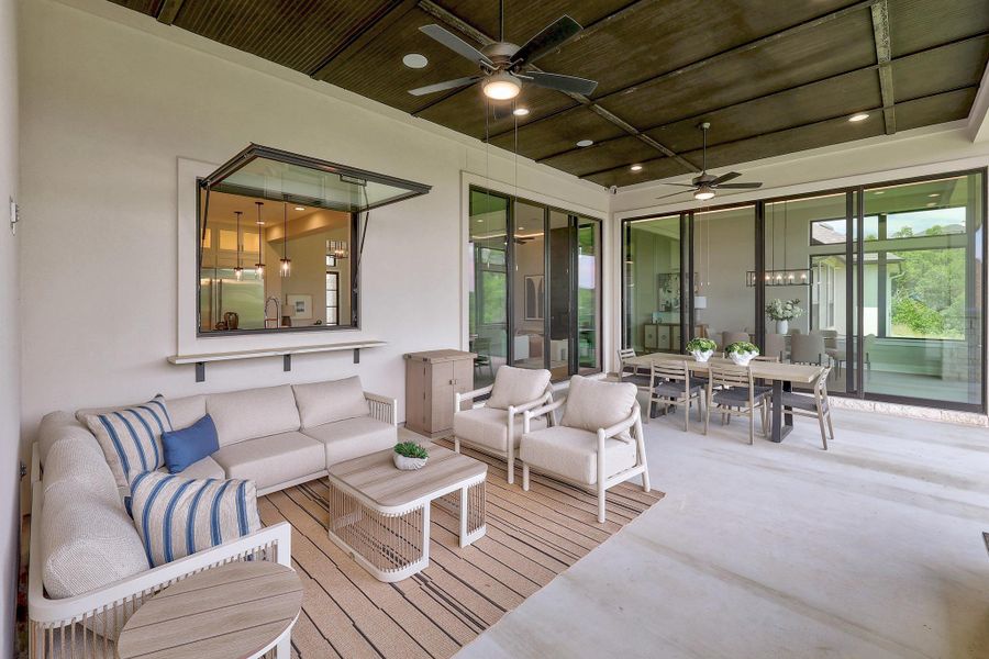 An inviting outdoor living area seamlessly extends the interior, offering abundant space for gatherings.