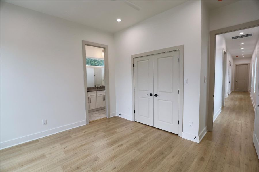 Third Bedroom, french warm toned closet doors, notice the vast distance to the primary suite offering privacy. Third Bedroom, french warm toned closet doors, notice the vast distance to the primary suite offering privacy.