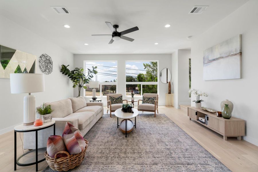 Living area featuring light wood-style floors, recessed lighting, and ceiling fan