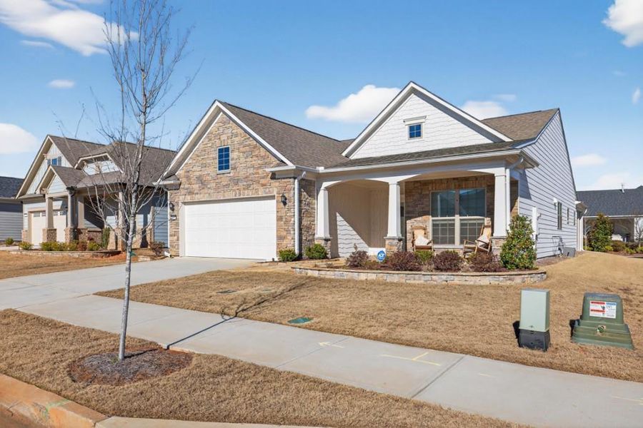 Front exterior of a new home in Del Webb Chateau Elan, Hoschton, GA, highlighting curb appeal (Image 2). Front exterior of a new home in Del Webb Chateau Elan, Hoschton, GA, highlighting curb appeal (Image 2).