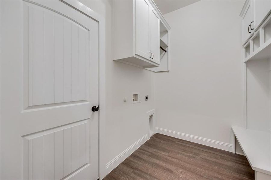Laundry area with hookup for an electric dryer, dark wood-style flooring, gas dryer hookup, cabinet space, and hookup for a washing machine