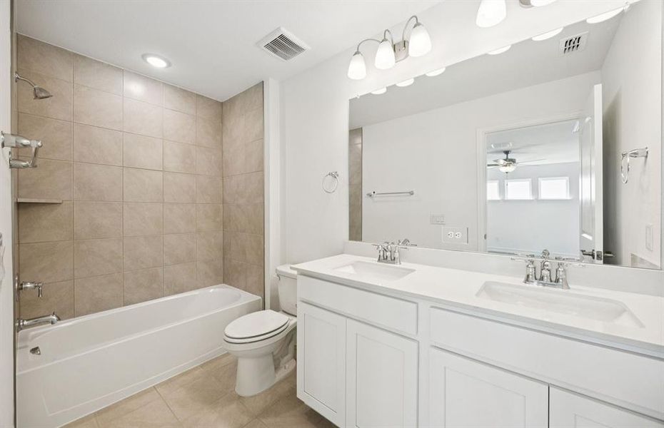 Secondary bathroom with double vanity and premium finishes