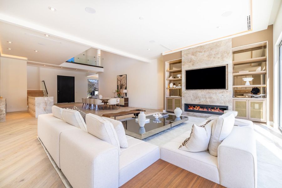 View of living room looking into the dining room and front entrance. View of living room looking into the dining room and front entrance.