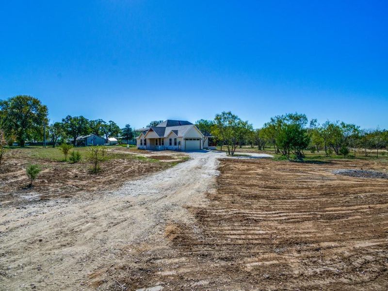 View of front of home featuring a rural view and a garage