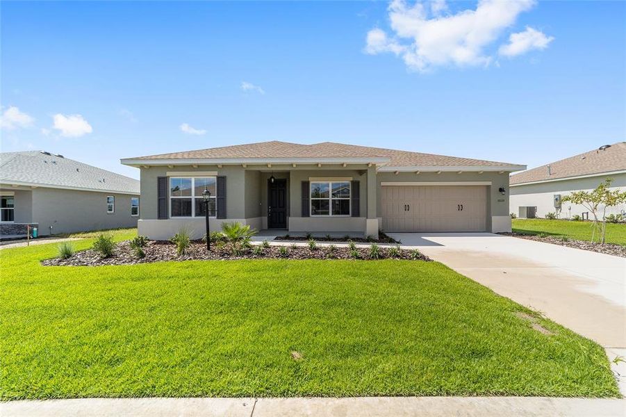 Front exterior of a new home in On Top of the World Communities, Ocala, FL, highlighting curb appeal (Image 20). Front exterior of a new home in On Top of the World Communities, Ocala, FL, highlighting curb appeal (Image 20).