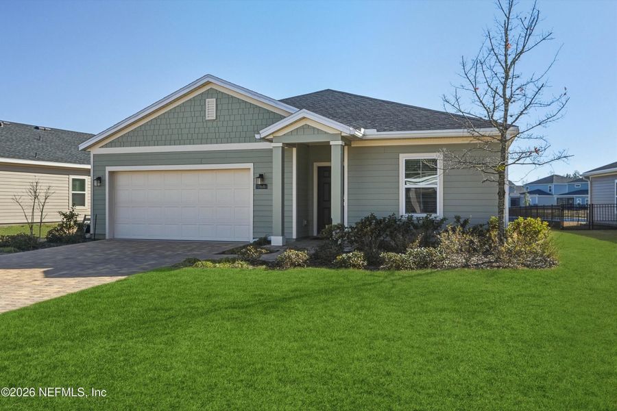 Front exterior of a new home in St Augustine Lakes, St. Augustine, FL, highlighting curb appeal (Image 24).