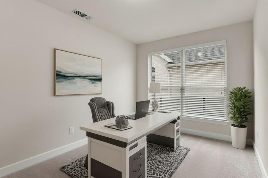 Office area with light carpet and baseboards