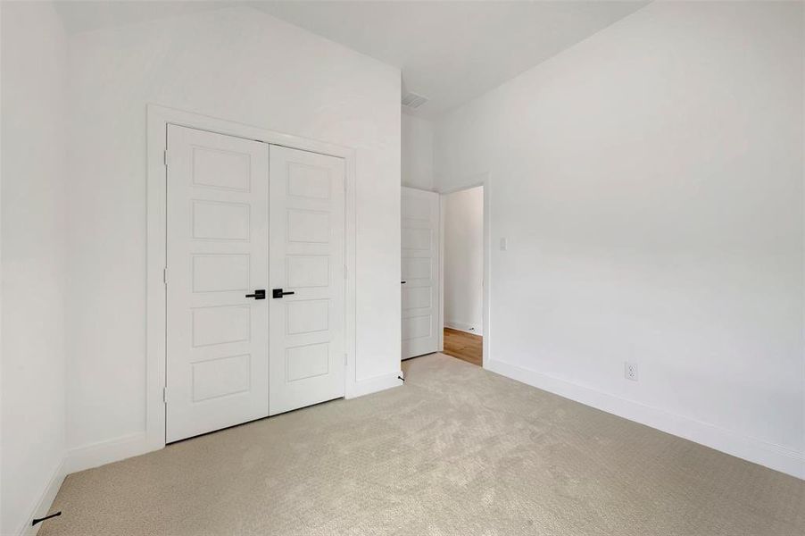 Room featuring neutral carpeting, crisp white walls, and bright white trim