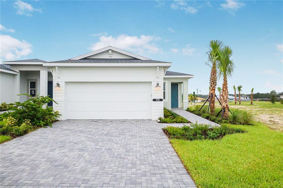 Front exterior of a new home in Cresswind at Hammock Oaks, Lady Lake, FL, highlighting curb appeal (Image 2).