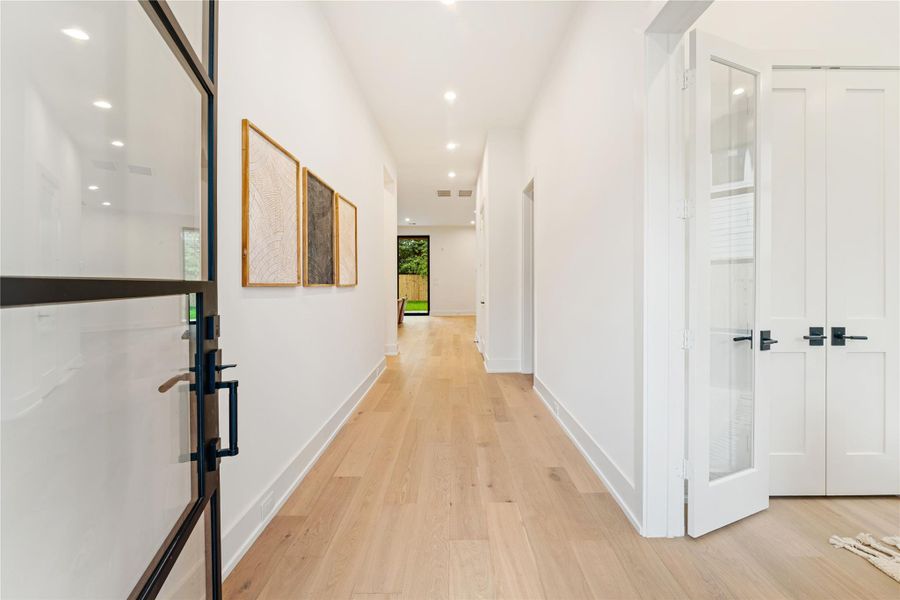 Welcome guests through this stunning glass and iron door entrance, into a bright and spacious hallway foyer.