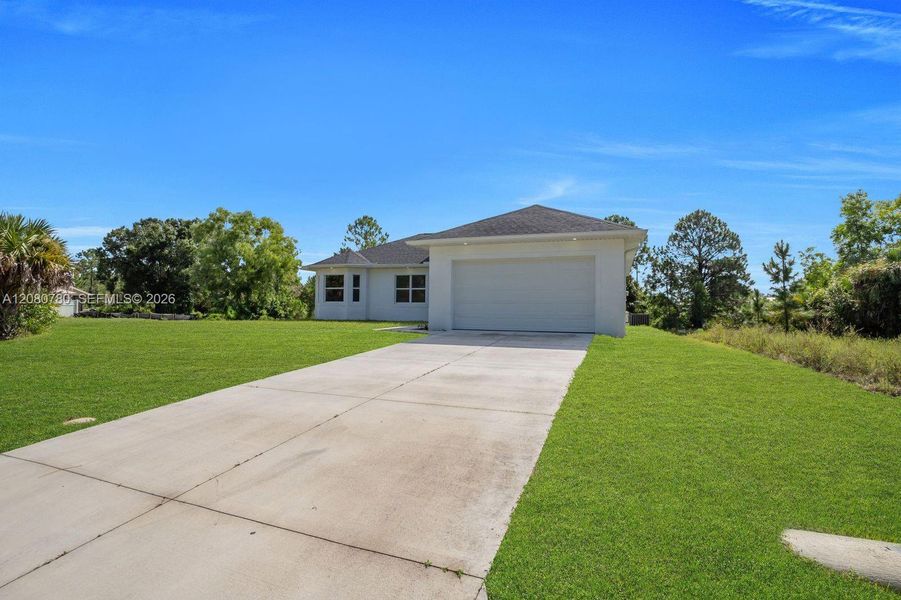 Front exterior of a new home in , Lehigh Acres, FL, highlighting curb appeal (Image 1). Front exterior of a new home in , Lehigh Acres, FL, highlighting curb appeal (Image 1).