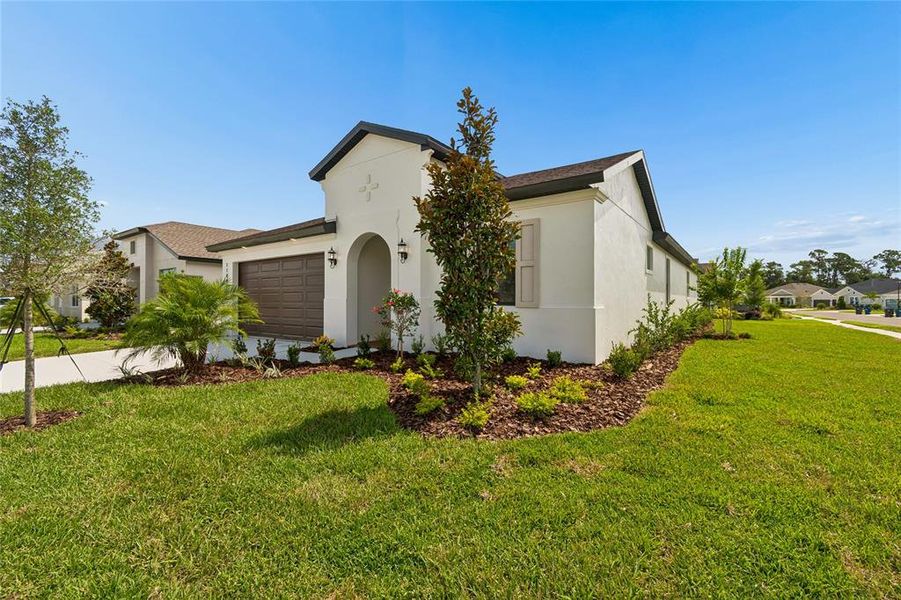 Front exterior of a new home in Isles at Bayview, Parrish, FL, highlighting curb appeal (Image 27). Front exterior of a new home in Isles at Bayview, Parrish, FL, highlighting curb appeal (Image 27).